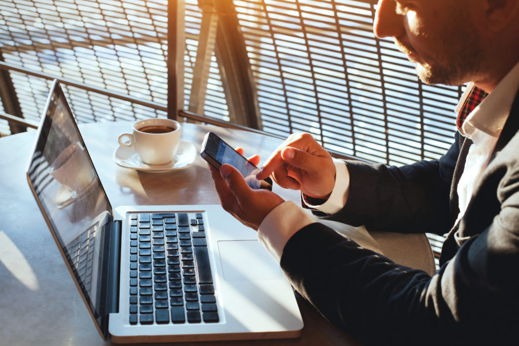 business man using internet on smart phone and laptop